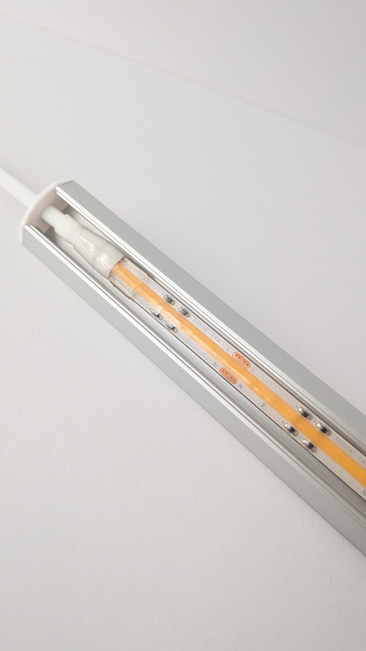 Daylight dotless corner LED light mounted under a cabinet, slim 19mm seamless profile