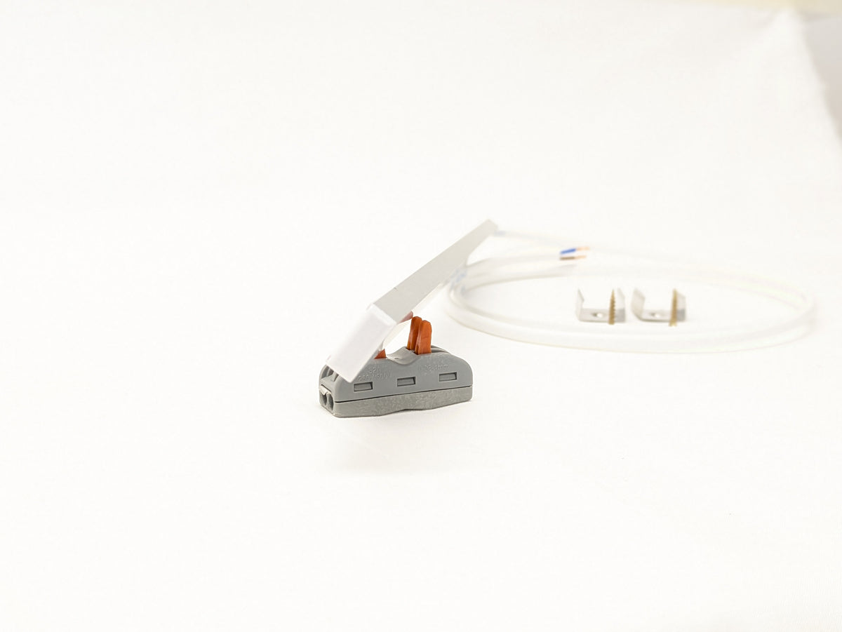 Warm white glow from a slim LED strip under a kitchen cabinet, lighting the counter below
