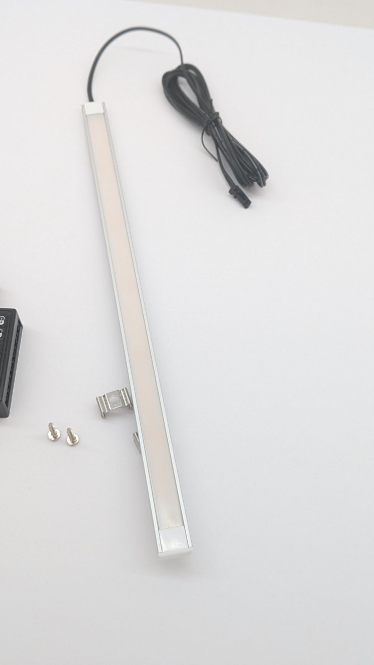 Seamless natural white LED neon strip recessed into a wardrobe or kitchen unit