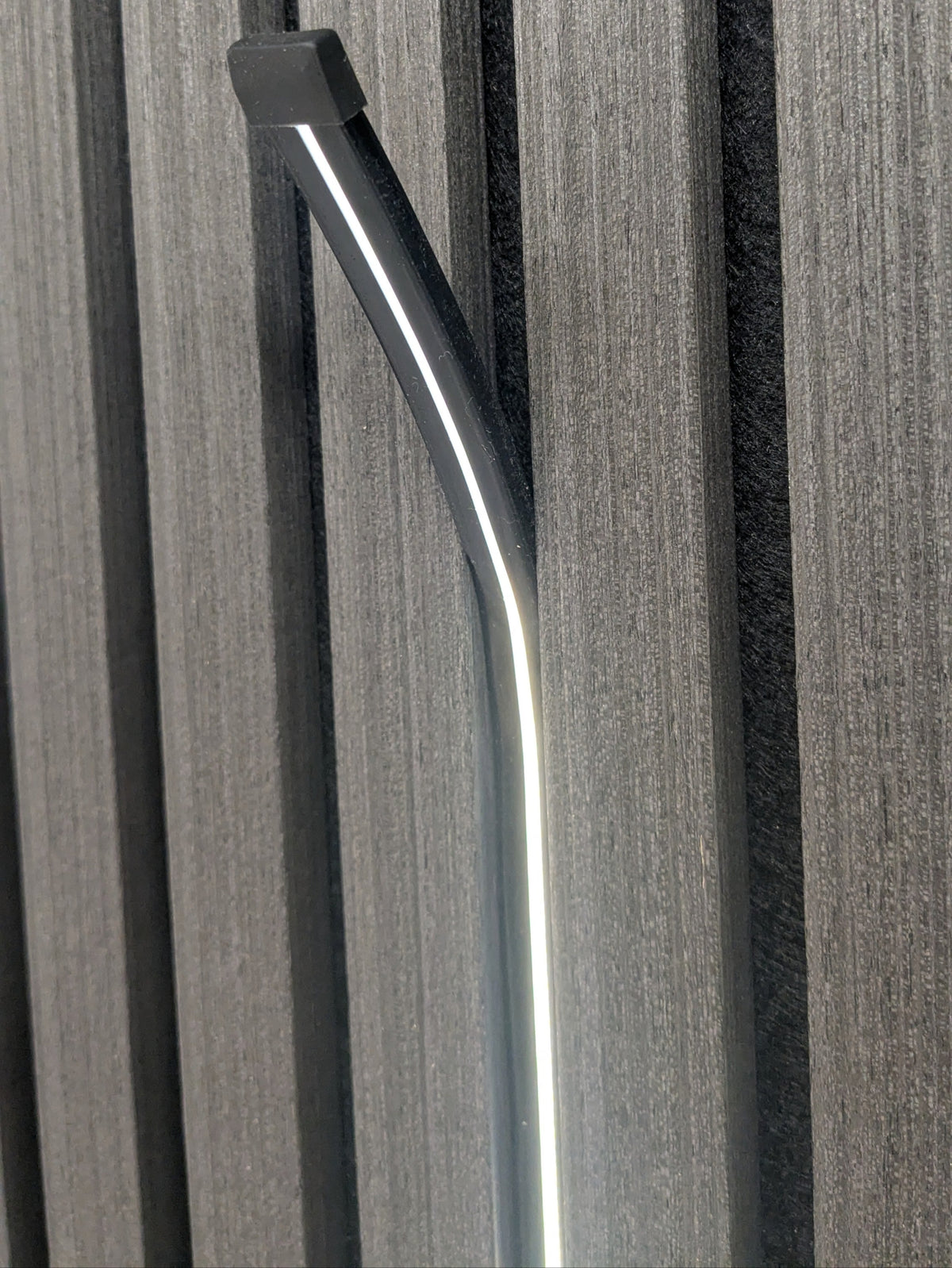 Plug and light LED strip fitted in the gap between acoustic slat panels