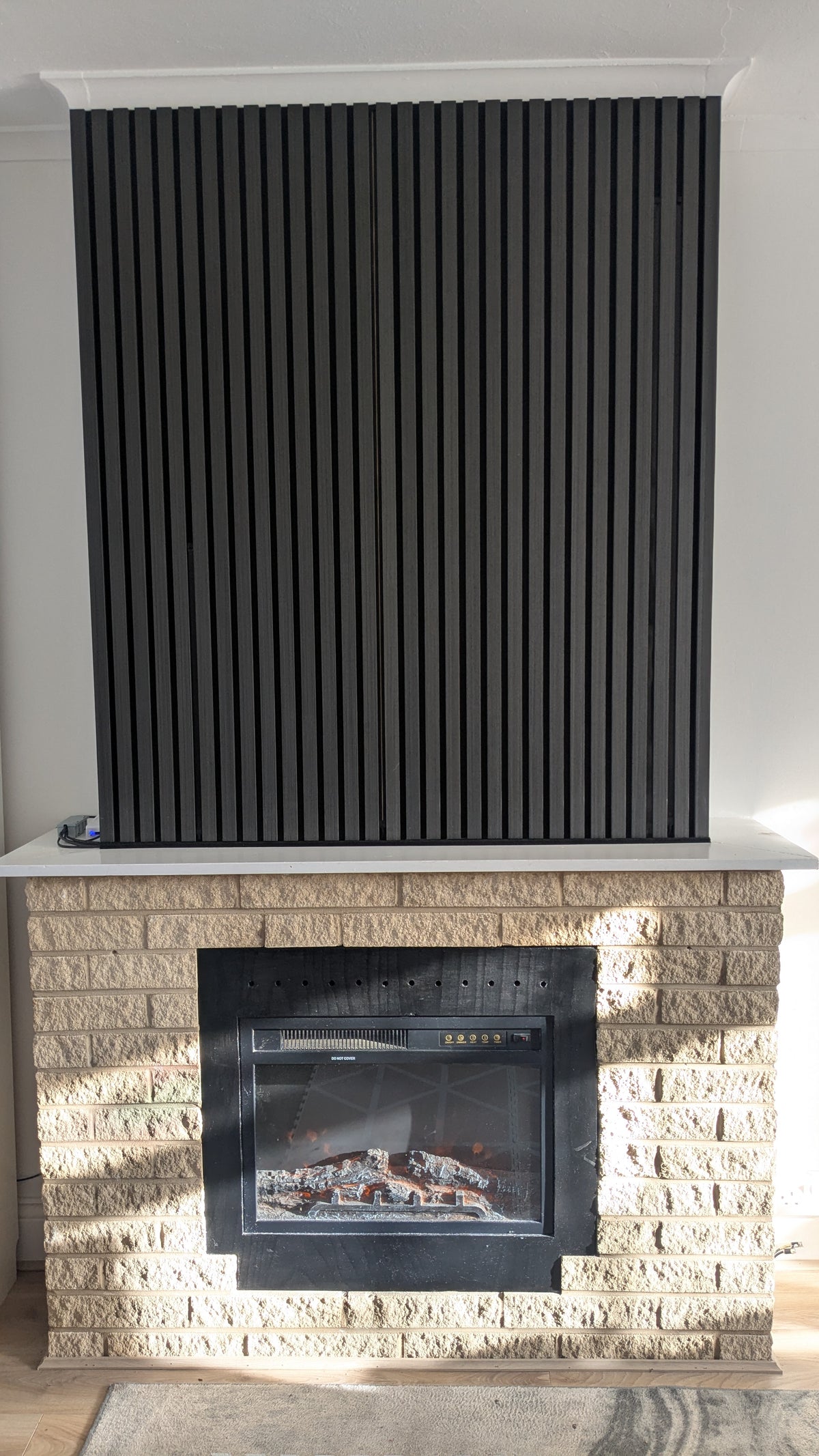 3000K warm white LED light slotted into an acoustic slat panel wall