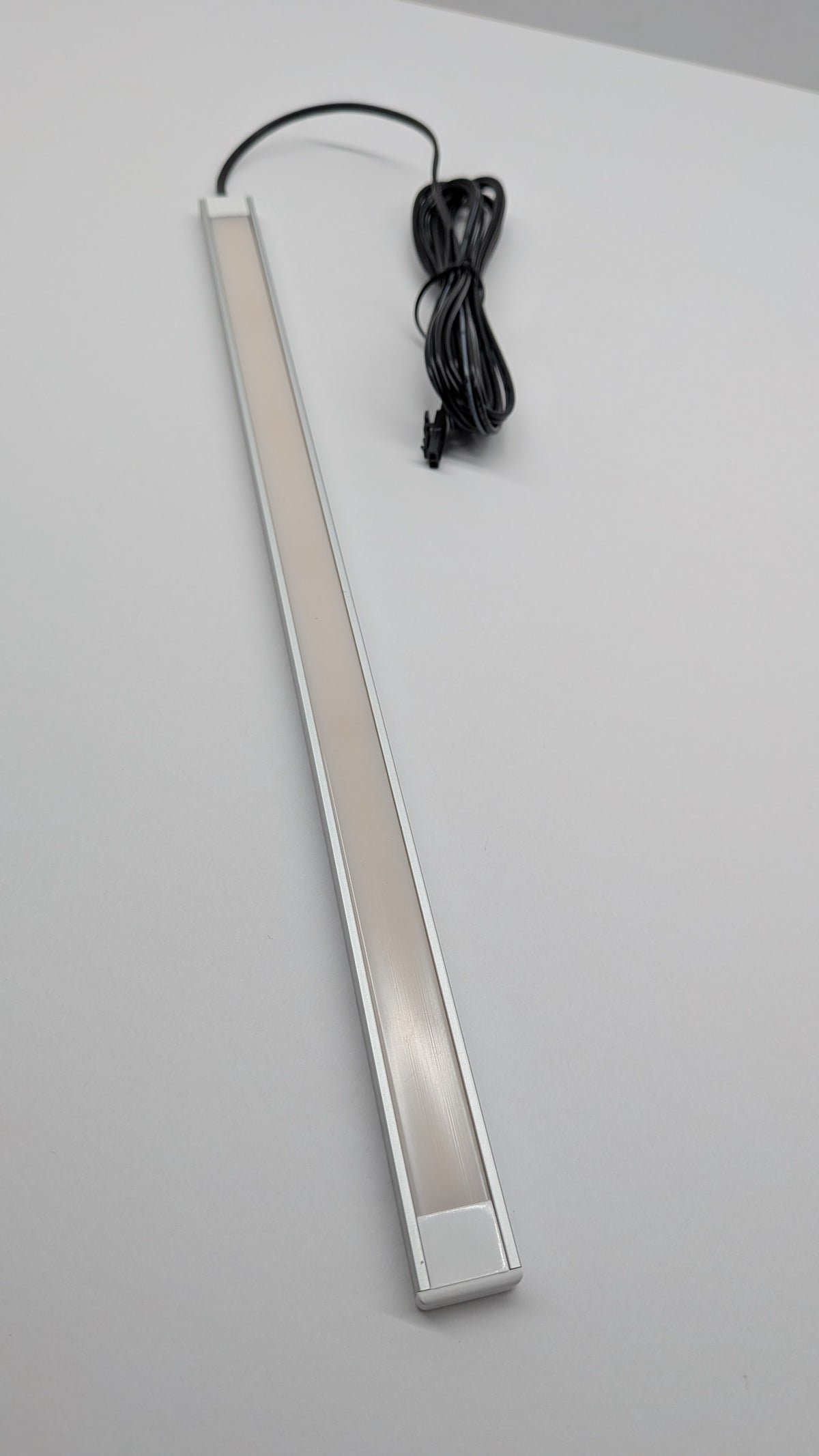 Smooth diffused LED strip light fitted inside a wardrobe, lighting hanging clothes evenly