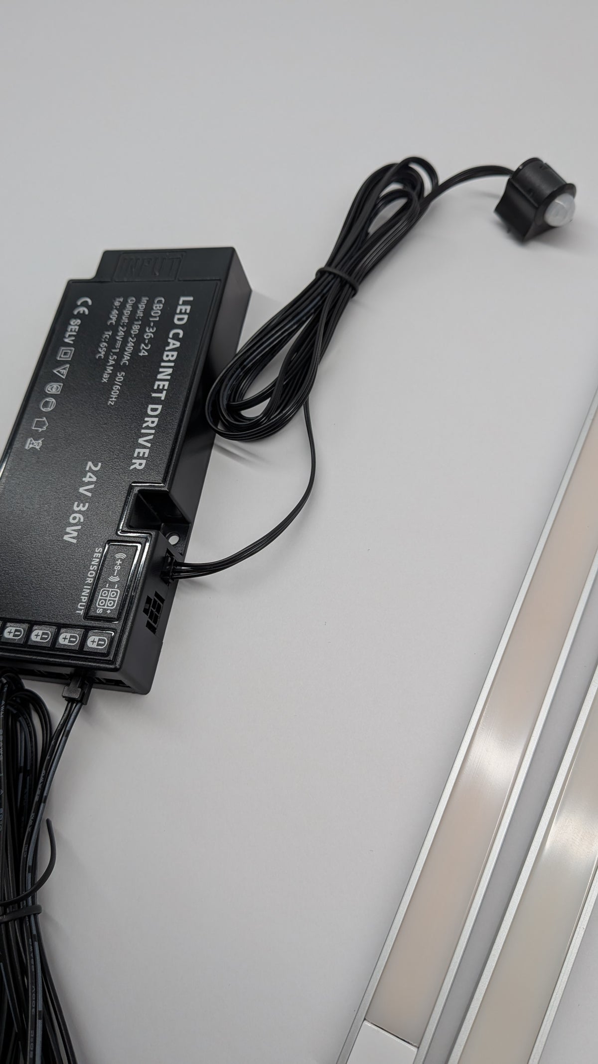 Close-up of a dotless LED strip in an aluminium channel showing smooth, diffused light