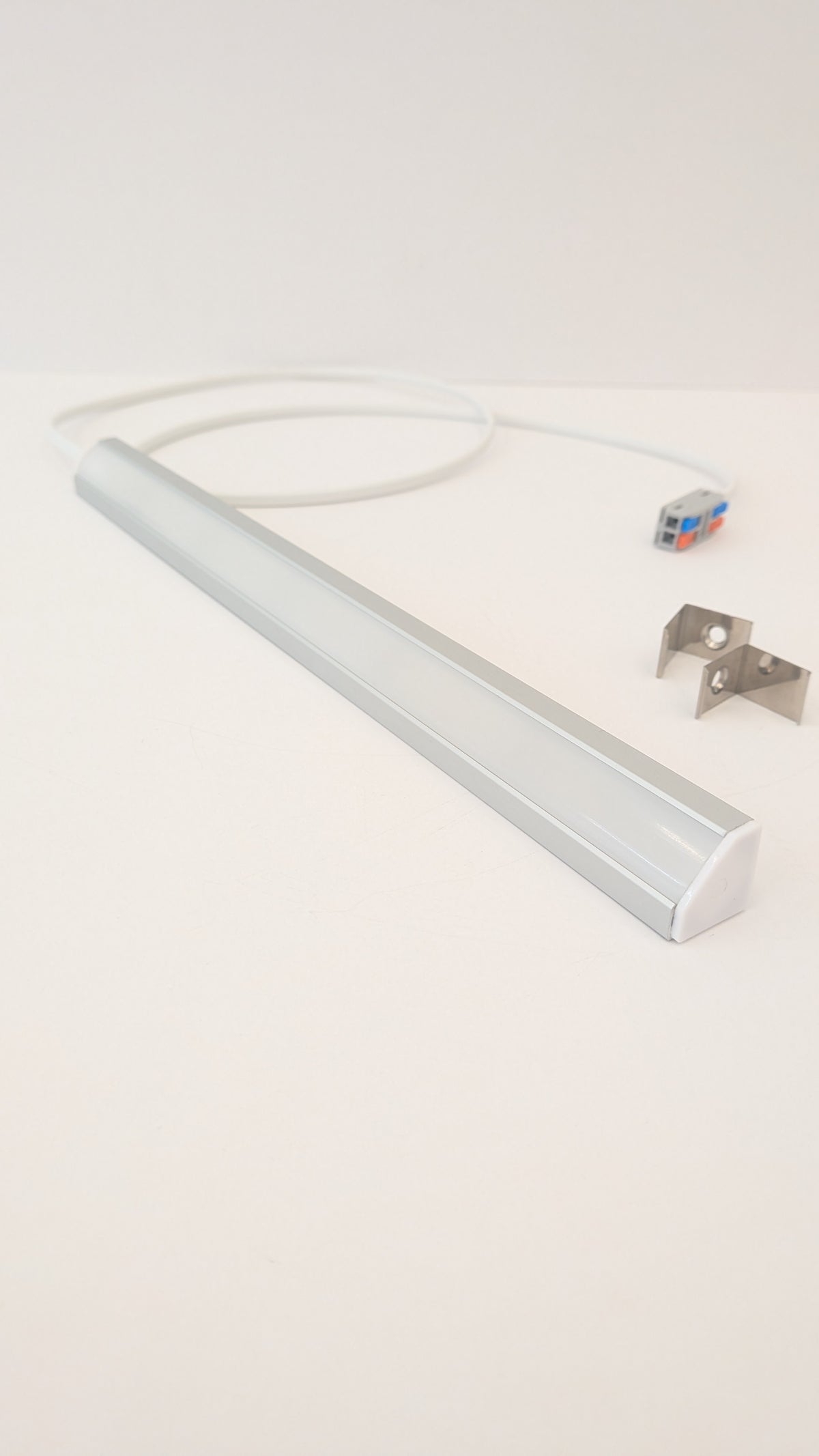 Ultra-slim 19mm high CRI LED corner light mounted beneath a wall cabinet, shown in warm white and daylight