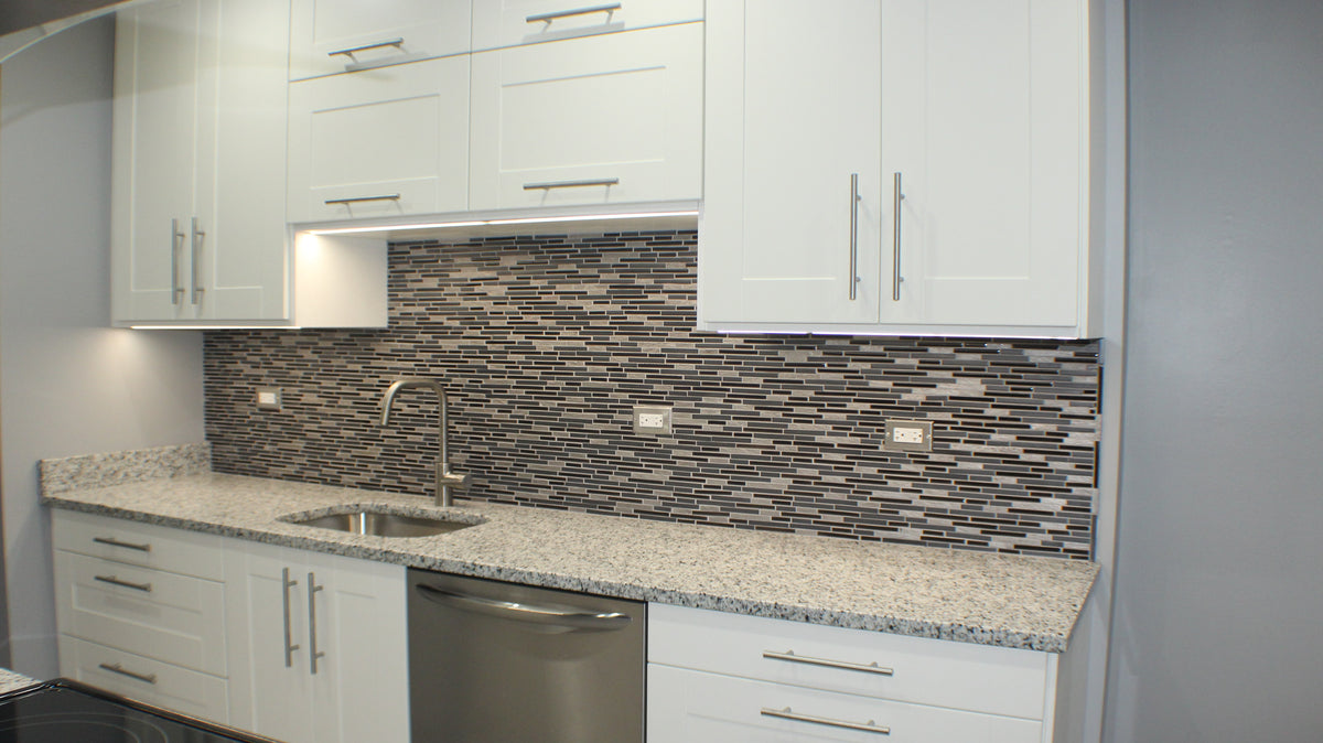 Discreet slim LED strip mounted at the front edge of a kitchen cupboard